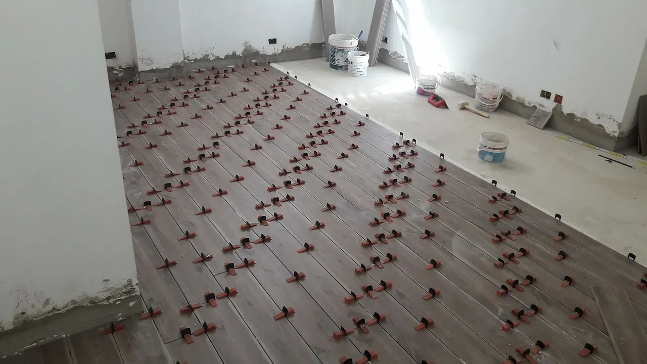 Floor and wall tiling in London: wood-effect plank tiles laid with levelling system