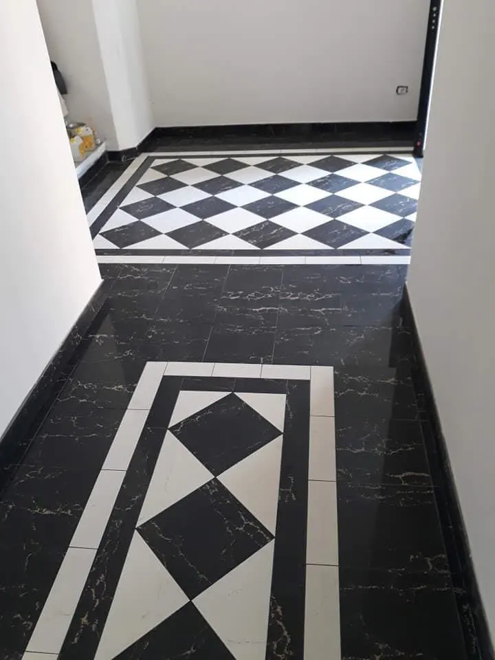 Floor and wall tiling in London: black marble-effect floor with checkerboard and diamond inlay