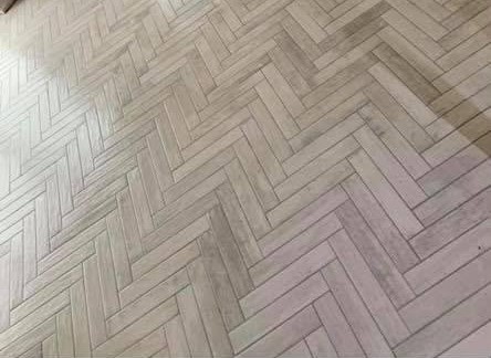 Wooden flooring in London: pale wood-effect herringbone floor