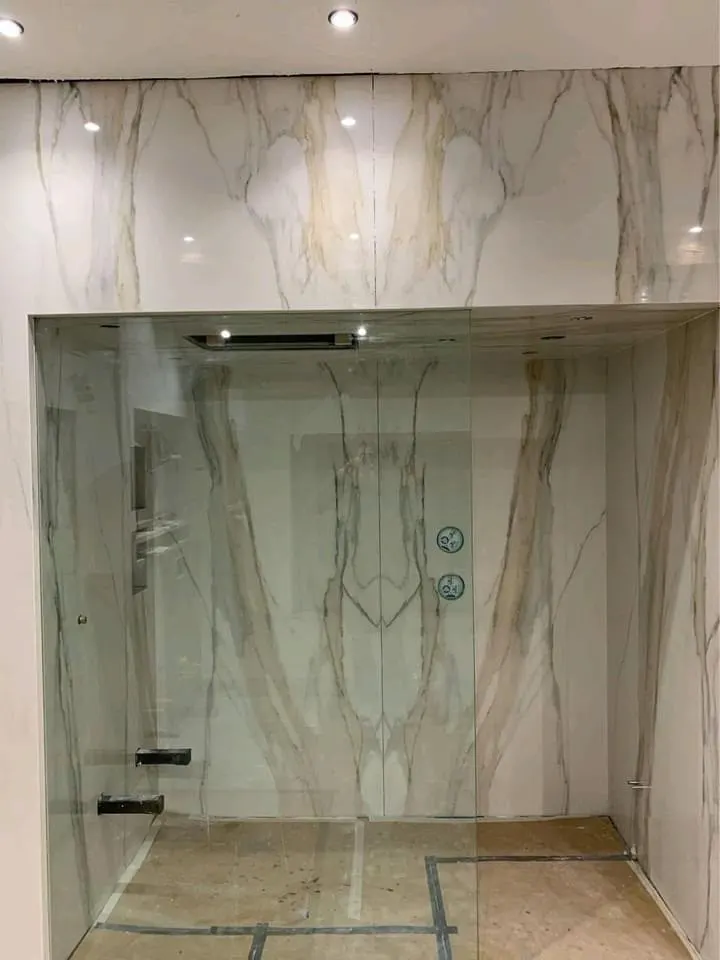 Bathroom renovation in London: marble-effect shower enclosure under construction