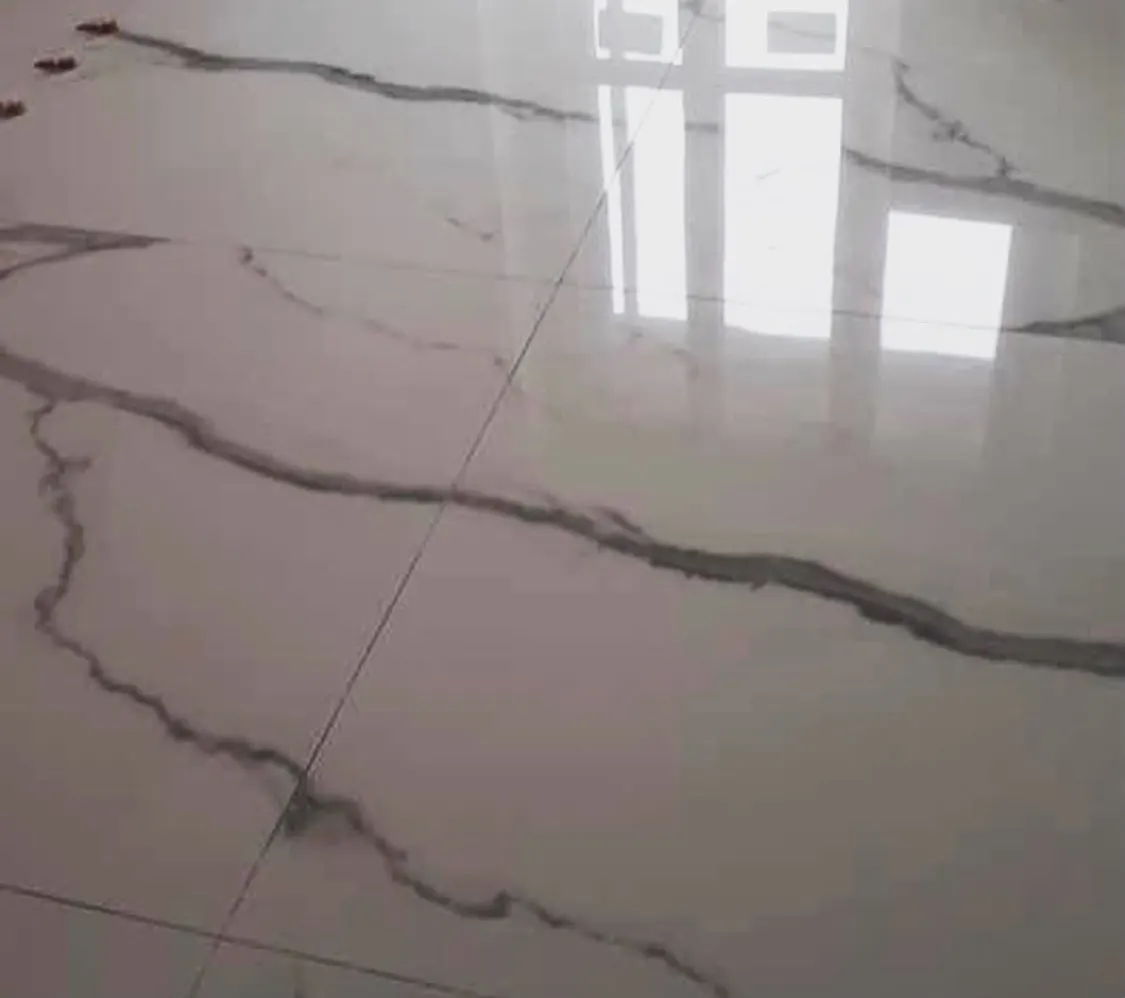 Floor and wall tiling in London: close-up of polished marble-effect floor tile joints