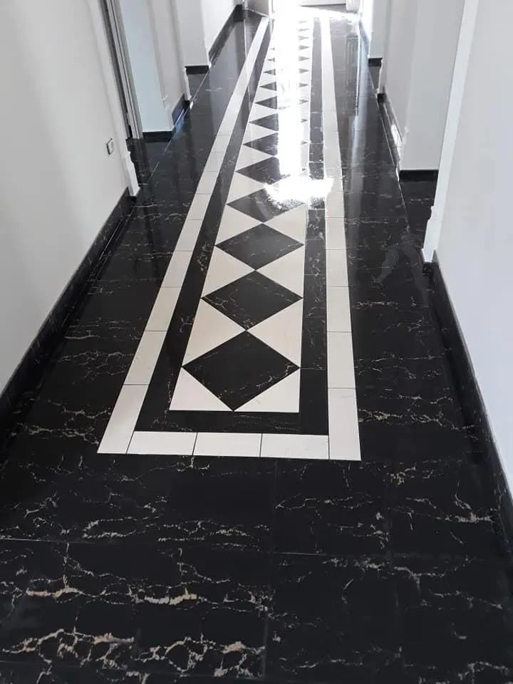 Floor and wall tiling in London: dark hallway floor with black and white geometric border