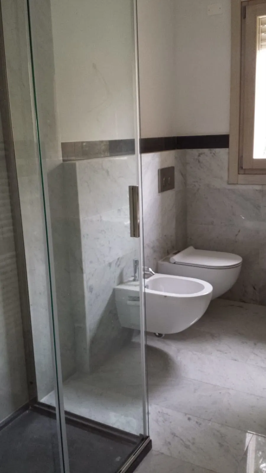 Marble and stone installation in London: Carrara marble bathroom walls and floor