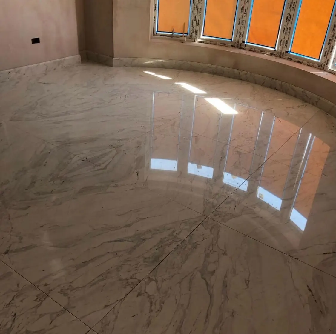 Marble and stone installation in London: polished marble floor in a bay-windowed room